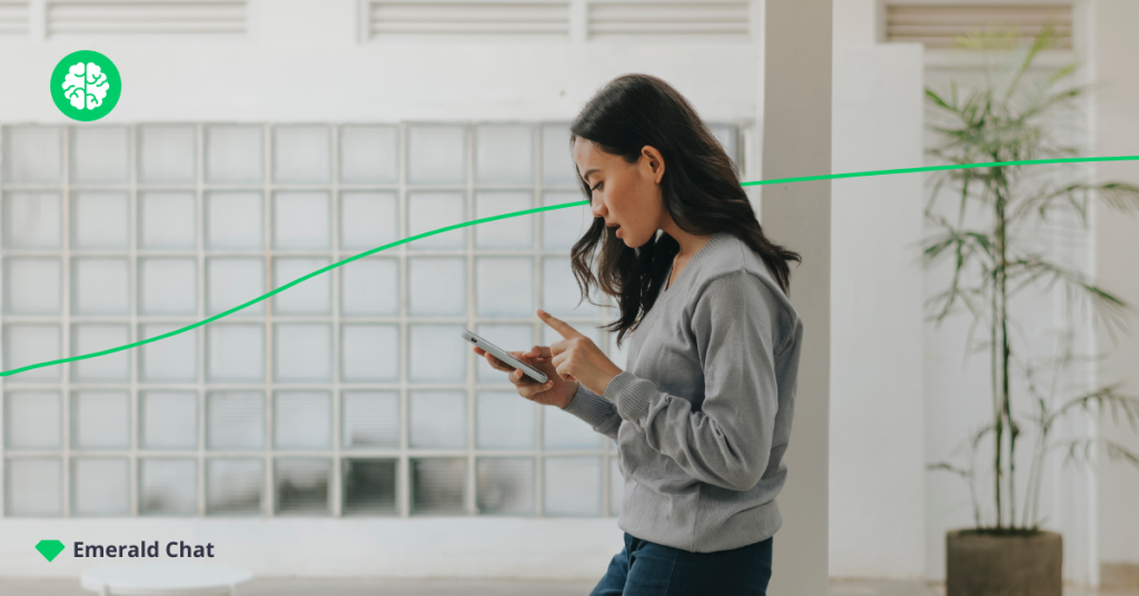 photo of girl's side profile, looking at her phone while walking